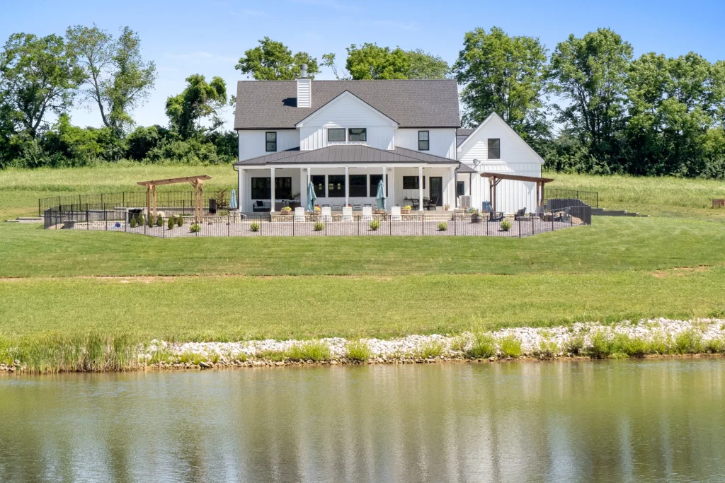 Stockell Custom Homes photo of the front of a white home by the lake