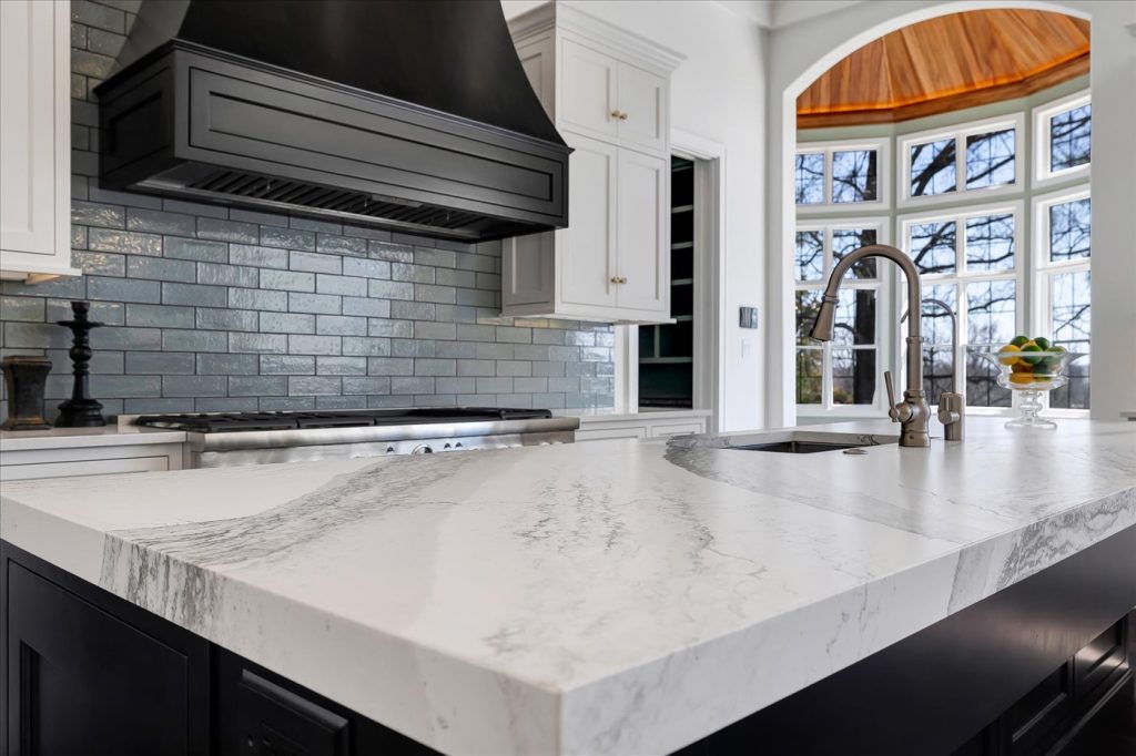 Stockell Custom Homes photo of kitchen island and appliances with view into breakfast room