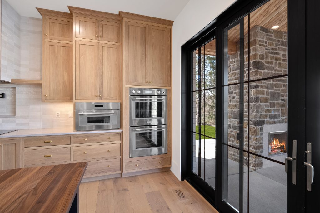 Stockell Custom Homes photo of kitchen with view of walkout patio fireplace